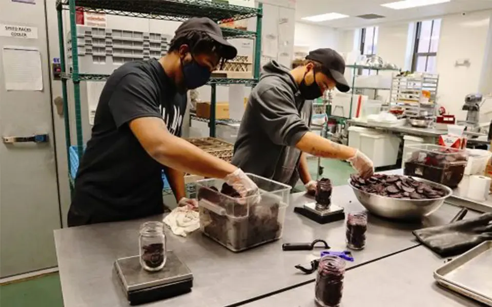 Community members preparing food together in a kitchen