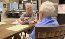 two elderly women playing cards