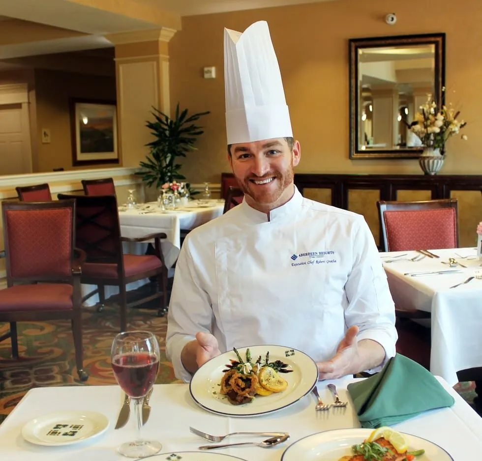 a chef showing the food he prepared