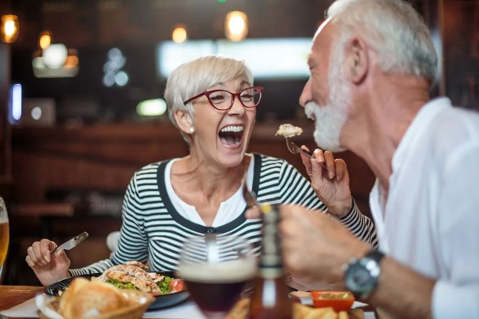 a woman feeding a man