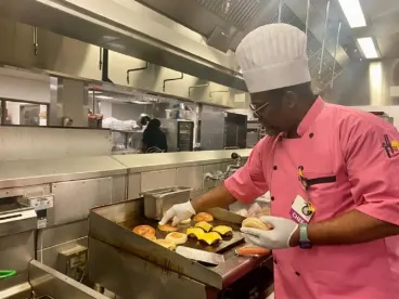 a chef preparing cheese burgers