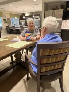 two elderly women playing cards