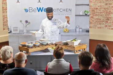 a chef preparing food for senior dining event